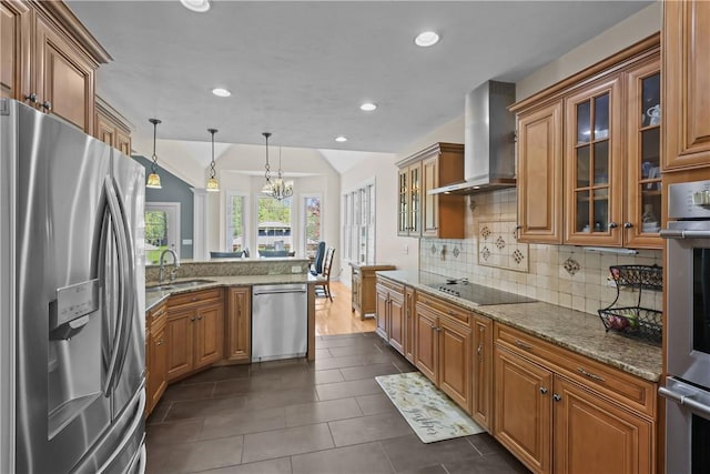 115 Read St, Attleboro, MA 02703 - kitchen featuring stainless steel appliances, wall chimney range hood, a sink, brown cabinets, and tasteful backsplash