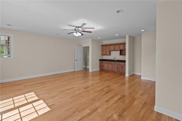 115 Read St, Attleboro, MA 02703 - unfurnished living room featuring light wood-type flooring, ceiling fan, baseboards, a sink, and recessed lighting