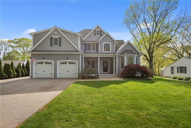 115 Read St, Attleboro, MA 02703 - view of front facade with asphalt driveway, an attached garage, a front lawn, and a porch