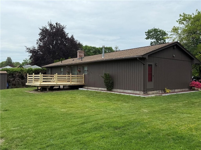 446 Angell Rd, North Providence, RI 02904 - rear view of house with a deck, a chimney, and a lawn
