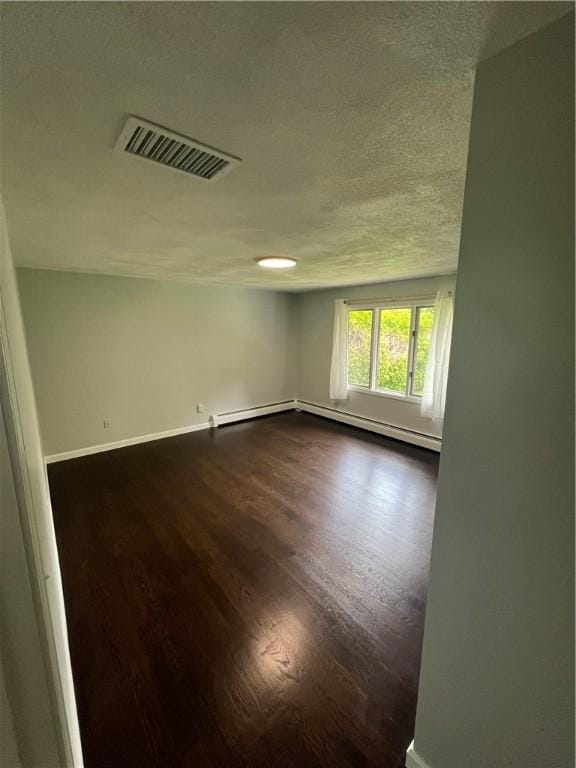 446 Angell Rd, North Providence, RI 02904 - empty room with dark wood-style floors, baseboards, a baseboard heating unit, and a textured ceiling
