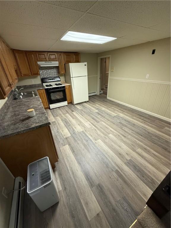 446 Angell Rd, North Providence, RI 02904 - kitchen with gas range, freestanding refrigerator, a sink, under cabinet range hood, and light wood-type flooring