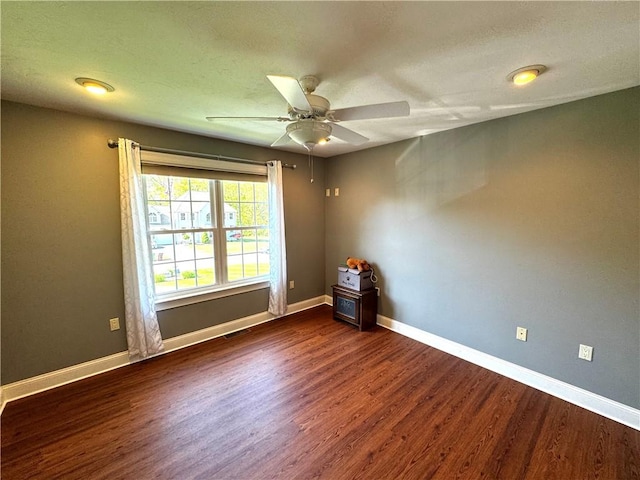 unfurnished room featuring wood finished floors, ceiling fan, and baseboards