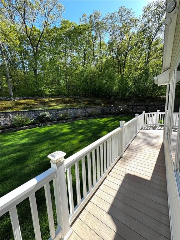 wooden deck with a lawn