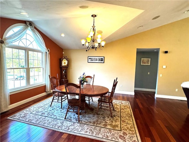 dining area with lofted ceiling, a chandelier, wood finished floors, and baseboards