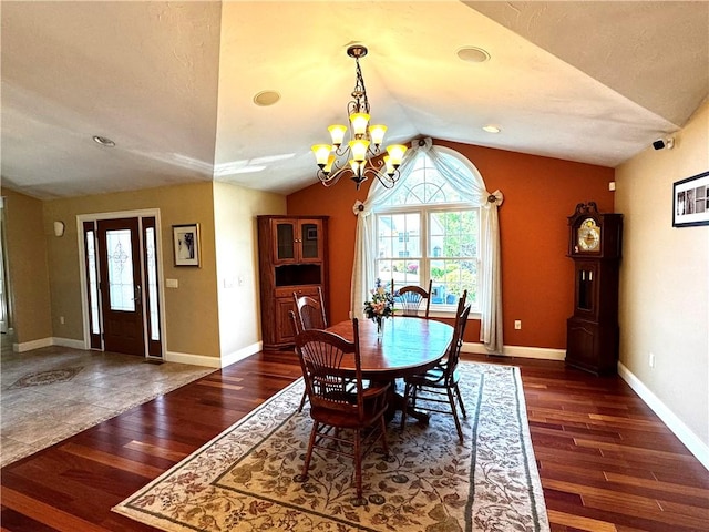 dining room with lofted ceiling, wood finished floors, a chandelier, baseboards, and recessed lighting