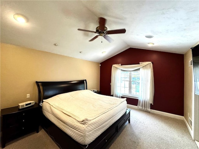 bedroom featuring lofted ceiling, light carpet, baseboards, and a ceiling fan