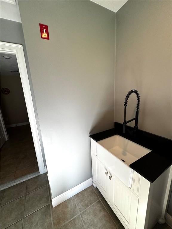 bathroom with tile patterned flooring, vanity, and baseboards