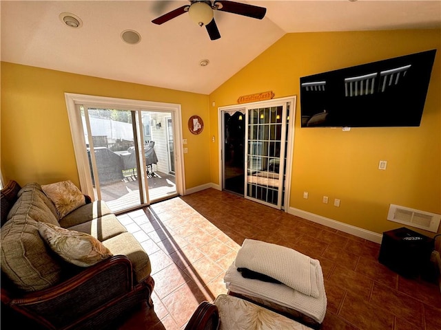 tiled living room with lofted ceiling, a ceiling fan, and baseboards