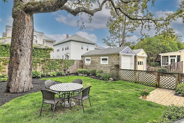 view of yard featuring an outdoor structure, a detached garage, and a patio area