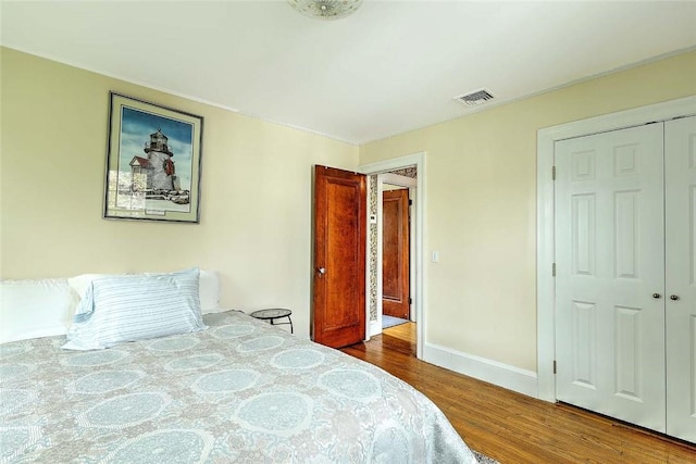 bedroom with wood finished floors and baseboards