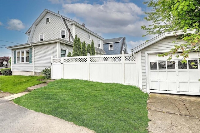 view of property exterior featuring an outdoor structure, a gambrel roof, a garage, and concrete driveway