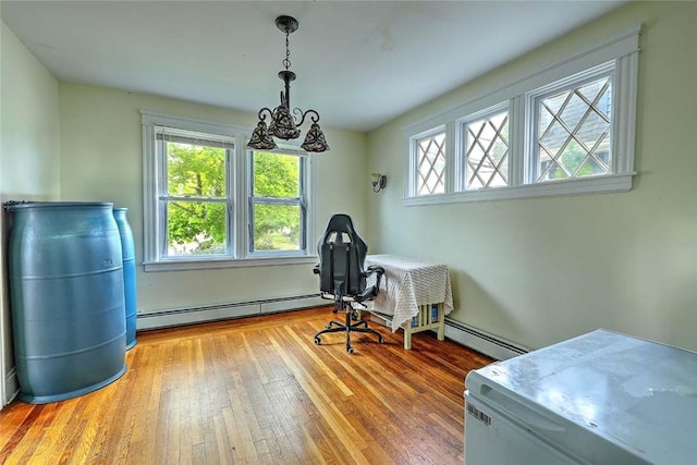 office featuring a baseboard heating unit, hardwood / wood-style floors, and a chandelier