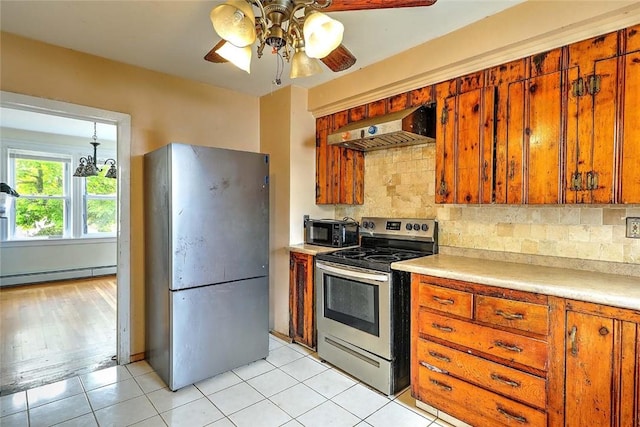 kitchen featuring appliances with stainless steel finishes, exhaust hood, a baseboard radiator, ceiling fan, and brown cabinetry
