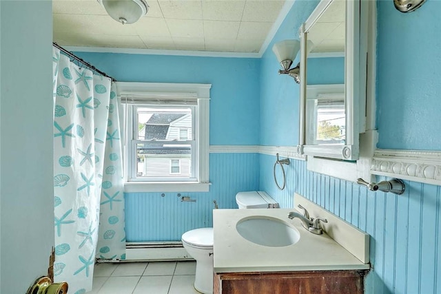 bathroom featuring a baseboard heating unit, toilet, crown molding, tile patterned flooring, and vanity