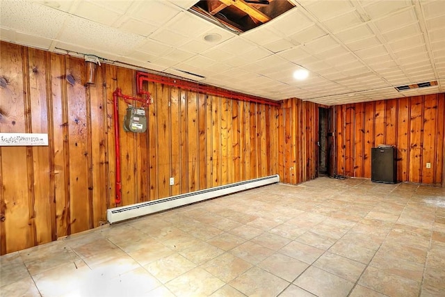 finished below grade area with baseboard heating and wooden walls