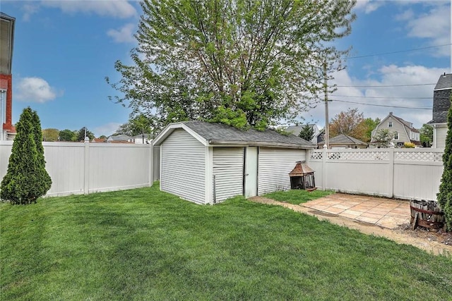 view of yard featuring a storage unit, an outbuilding, and a patio area