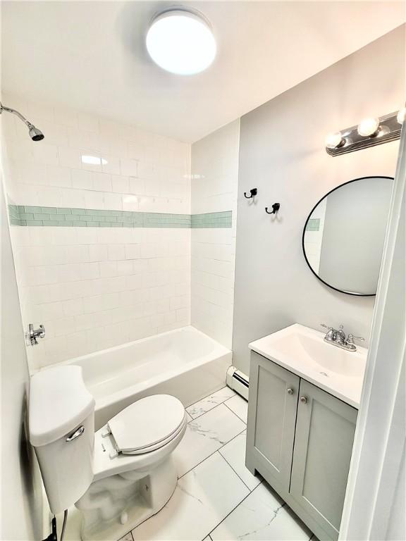 bathroom featuring toilet, marble look tile flooring, a baseboard radiator, tub / shower combination, and vanity