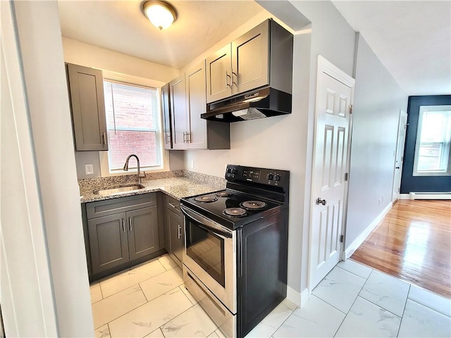 kitchen with stainless steel range with electric stovetop, under cabinet range hood, a sink, light marble finish flooring, and baseboards