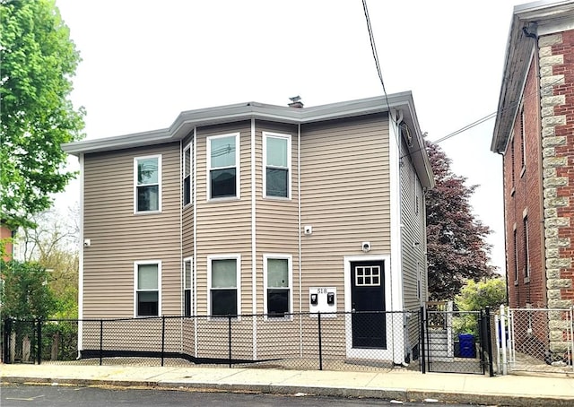 view of front facade with fence and a gate