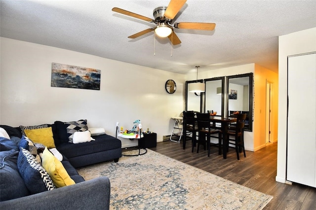 21 Apache Dr Unit D, Westerly, RI 02891 - living room with dark wood-type flooring, ceiling fan, a textured ceiling, and baseboards