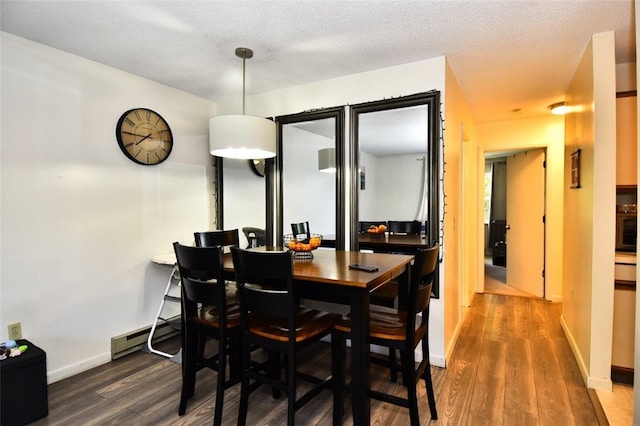 21 Apache Dr Unit D, Westerly, RI 02891 - dining area with dark wood-type flooring, a baseboard heating unit, and baseboards