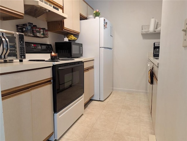 21 Apache Dr Unit D, Westerly, RI 02891 - kitchen with under cabinet range hood, electric range, black microwave, and light countertops