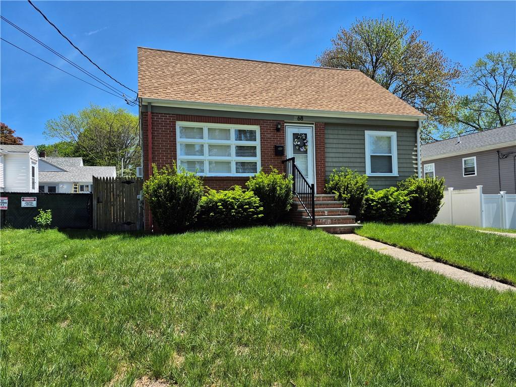 68 Boxwood Ave, Cranston, RI 02910 - view of front of house featuring a shingled roof, brick siding, and entry steps