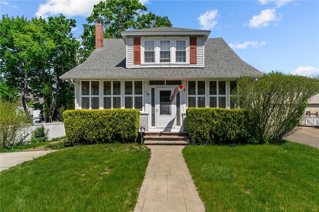 64 Dyer Ave, East Providence, RI 02915 - bungalow featuring a chimney, a front lawn, and a shingled roof
