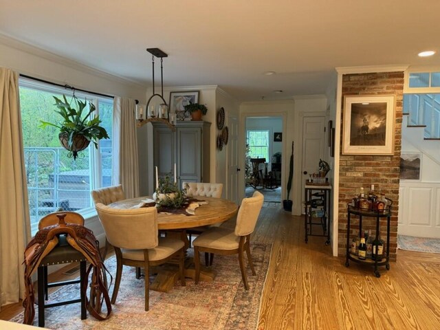 387 Camp Westwood Rd, Coventry, RI 02827 - dining space with light wood-style floors, crown molding, and stairway
