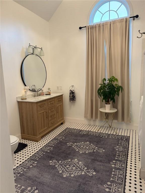 387 Camp Westwood Rd, Coventry, RI 02827 - full bathroom featuring baseboards, tile patterned flooring, vanity, and lofted ceiling