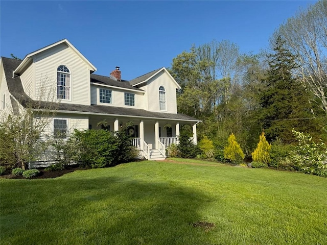 387 Camp Westwood Rd, Coventry, RI 02827 - view of front facade with a chimney, a porch, and a front yard