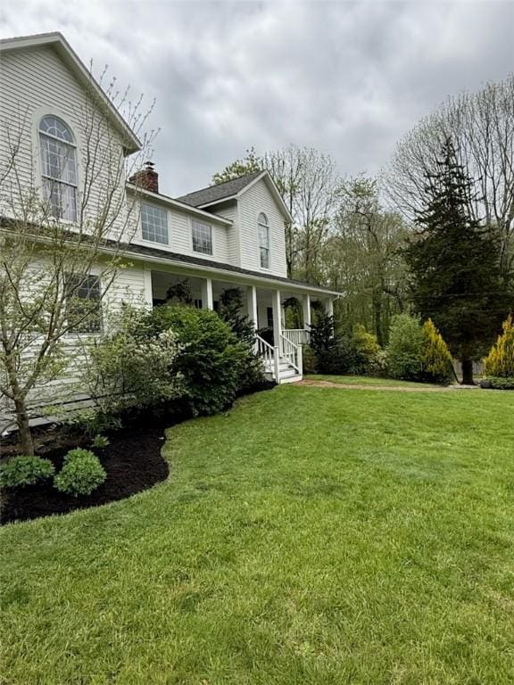 387 Camp Westwood Rd, Coventry, RI 02827 - view of front of property featuring a porch, a chimney, and a front yard