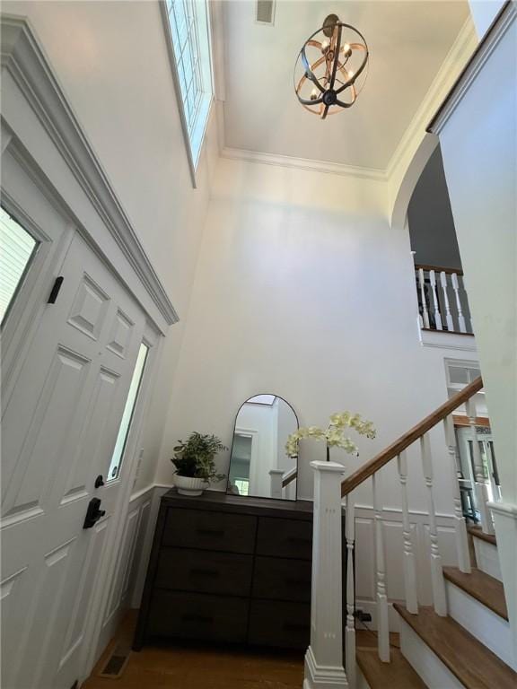 387 Camp Westwood Rd, Coventry, RI 02827 - foyer entrance featuring a high ceiling, stairs, arched walkways, and a chandelier
