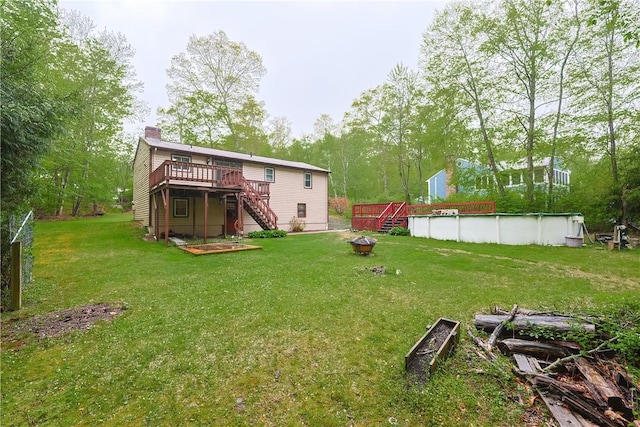 274 Courthouse Ln, Burrillville, RI 02859 - view of grassy yard featuring stairs, a deck, a covered pool, and a fire pit