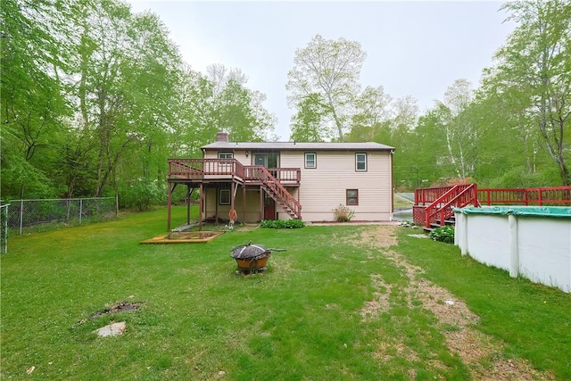 274 Courthouse Ln, Burrillville, RI 02859 - rear view of house with stairs, an outdoor fire pit, a wooden deck, and a chimney