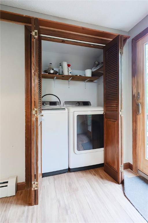 274 Courthouse Ln, Burrillville, RI 02859 - washroom featuring washer and clothes dryer, light wood-style floors, a baseboard radiator, and baseboards