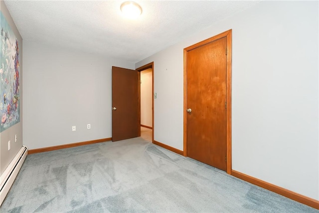 274 Courthouse Ln, Burrillville, RI 02859 - spare room with a baseboard radiator, light carpet, baseboards, and a textured ceiling