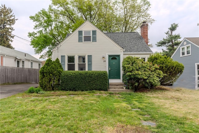 view of front of property with a chimney, entry steps, and a shingled roof