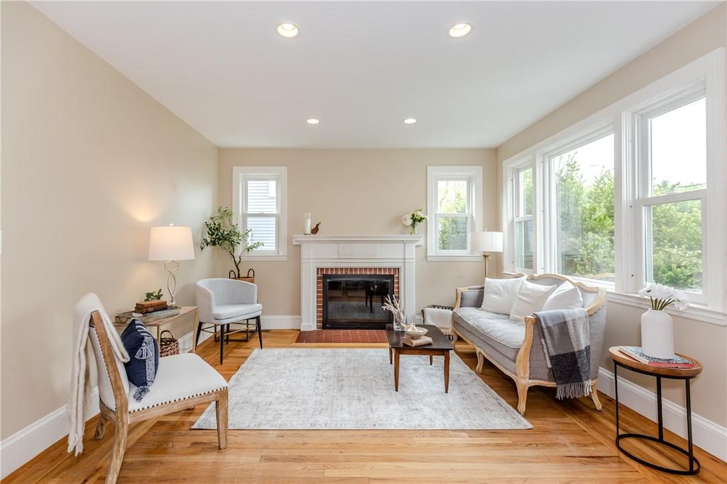 38 River St, Cranston, RI 02905 - living room with baseboards, a fireplace, light wood-style flooring, and recessed lighting