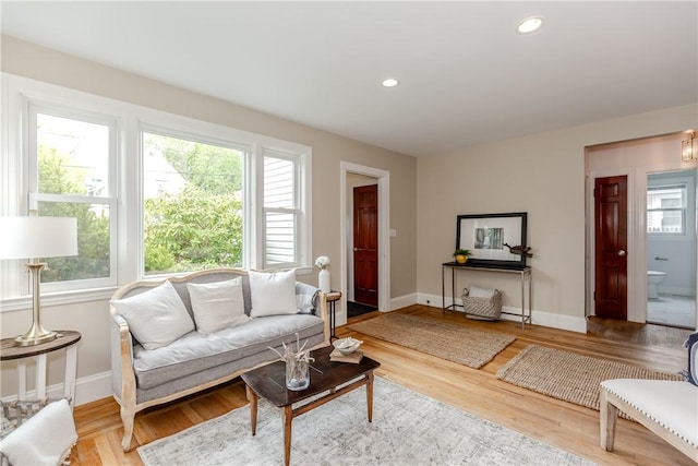 living area with plenty of natural light, baseboards, wood finished floors, and recessed lighting