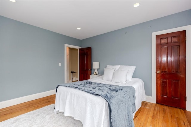 bedroom featuring light wood finished floors, baseboards, and recessed lighting
