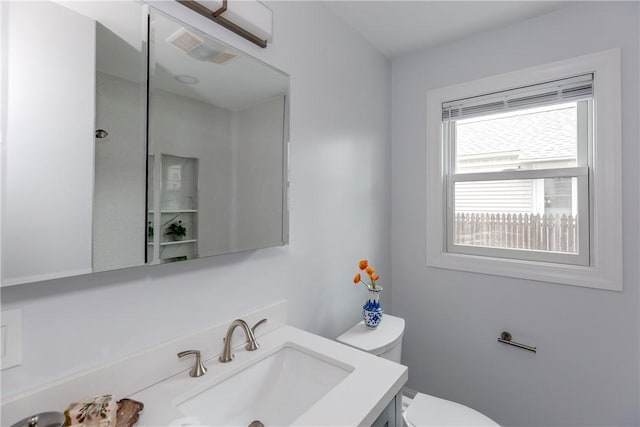 half bath featuring toilet and vanity