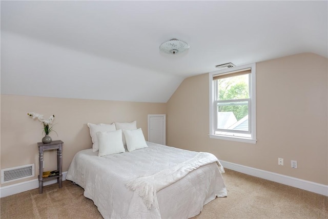 bedroom featuring vaulted ceiling, light colored carpet, and baseboards