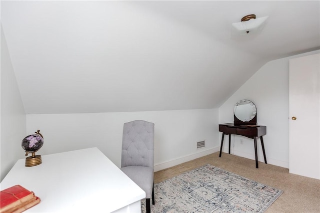 home office with lofted ceiling and carpet floors