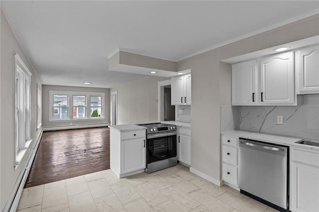 9 Lookout Ave, North Providence, RI 02911 - kitchen with stainless steel appliances, a peninsula, white cabinets, a baseboard heating unit, and recessed lighting
