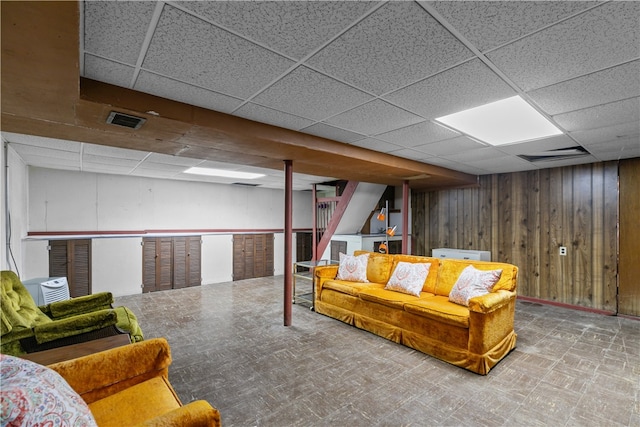 11 Cedar Ave, Middletown, RI 02842 - living room featuring a drop ceiling, wood walls, and stairway