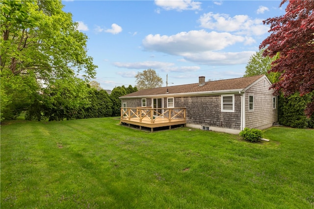 11 Cedar Ave, Middletown, RI 02842 - rear view of house featuring a chimney, a deck, a lawn, and a shingled roof