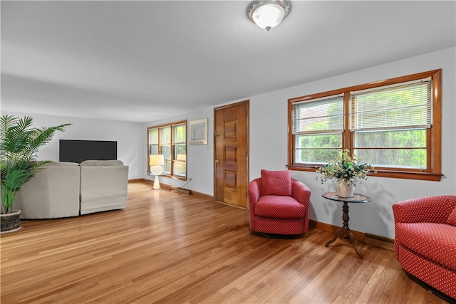 11 Cedar Ave, Middletown, RI 02842 - sitting room with light wood-style flooring and baseboards