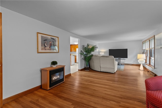 11 Cedar Ave, Middletown, RI 02842 - living room with wood finished floors, baseboards, and a fireplace